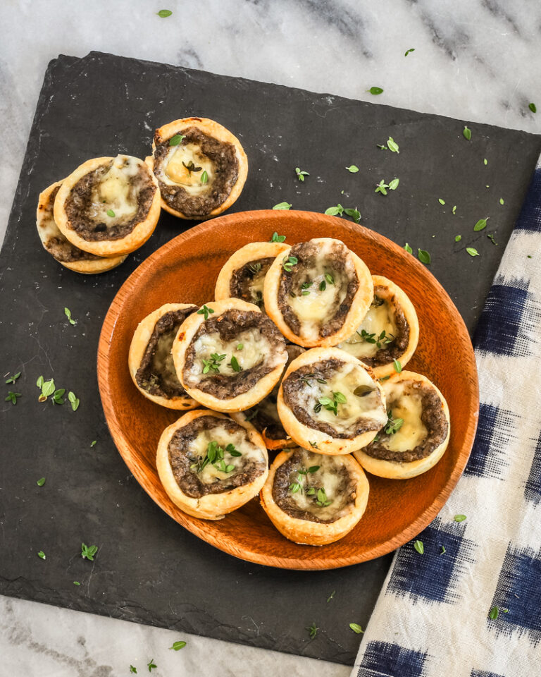 Tartlets with cream cheese pastry filled with mushroom duxelles and fontina cheese.