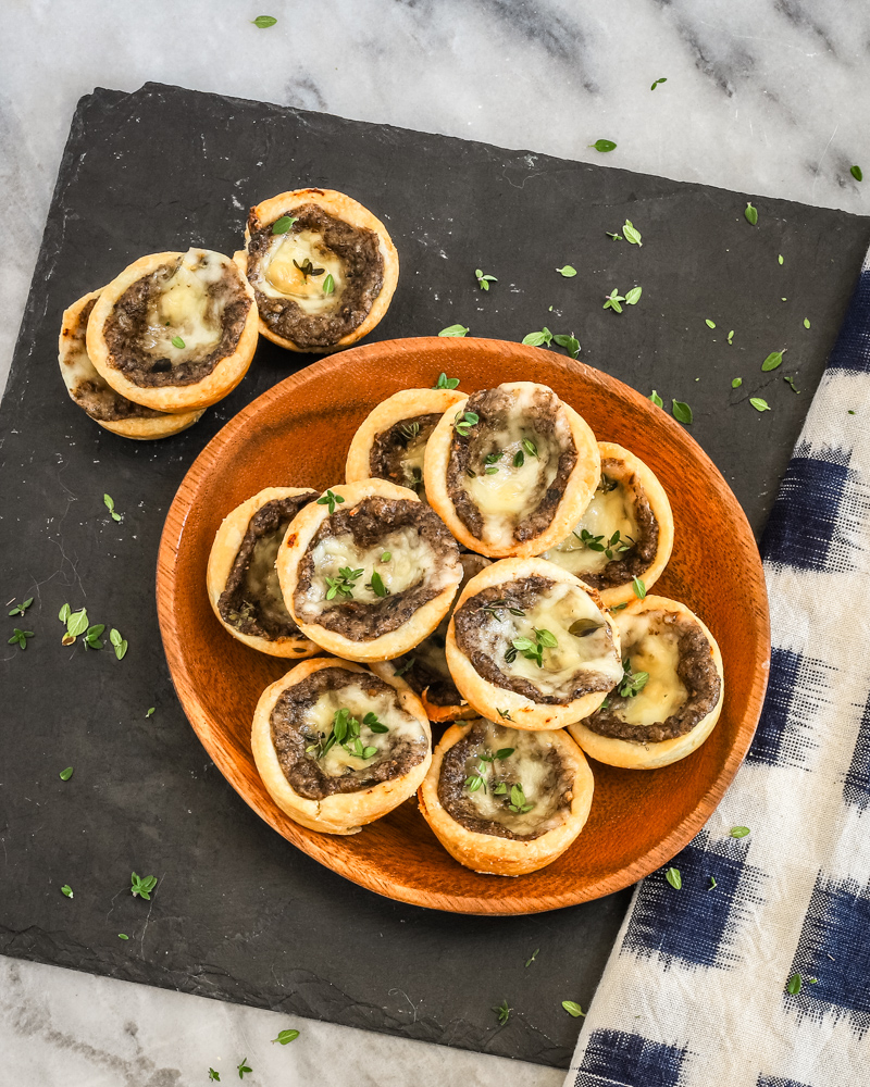 Tartlets with cream cheese pastry filled with mushroom duxelles and fontina cheese.