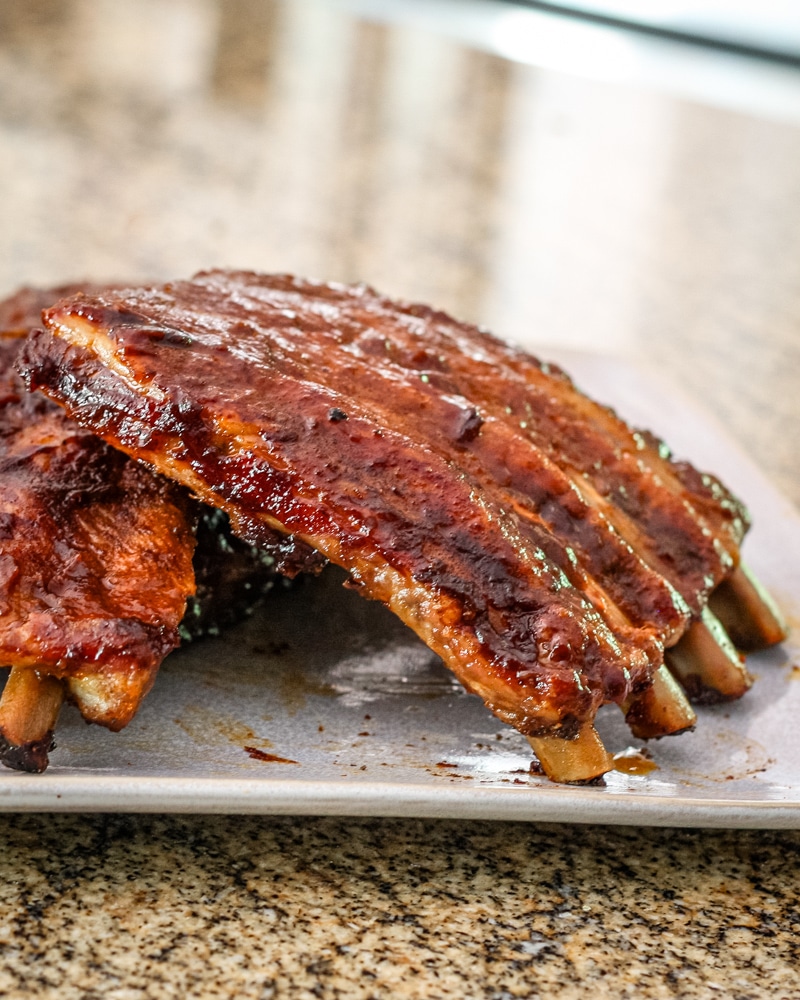 Oven barbecued spareribs on a plate.