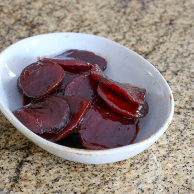 Sliced tangy beets in a small dish.