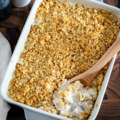 Serving up a baked Ritz chicken casserole with serving spoon.