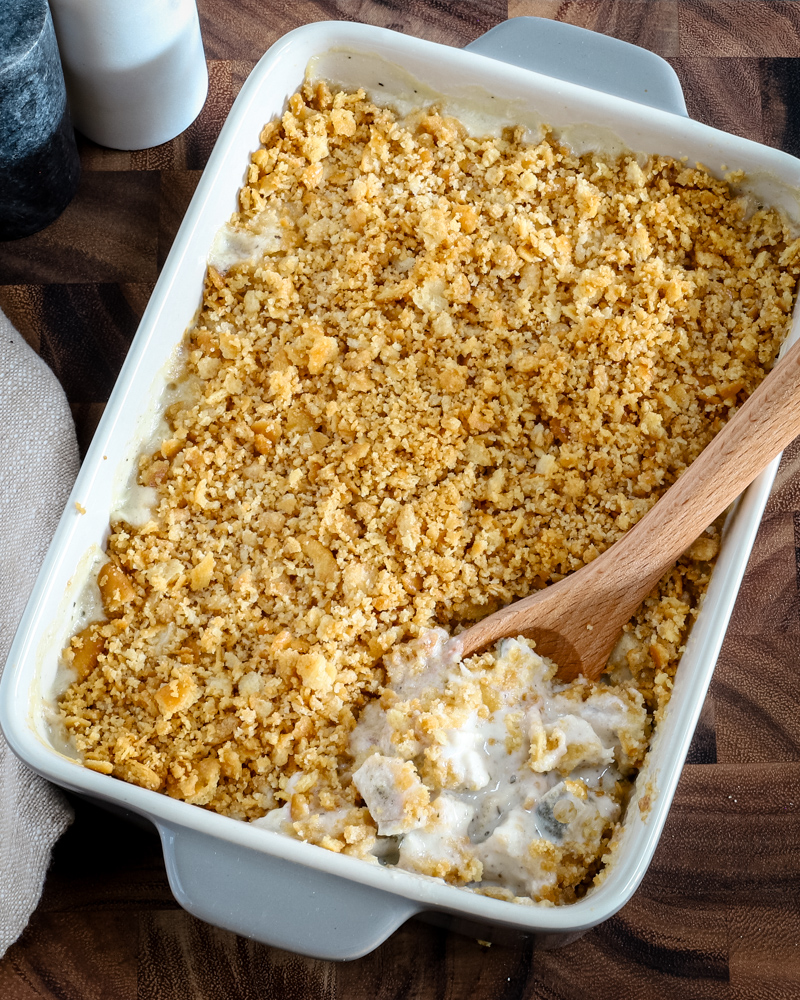 Serving up a baked Ritz chicken casserole with serving spoon.