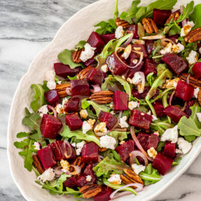 Roasted beet salad with goat cheese in a serving bowl.