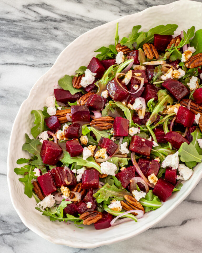 Roasted beet salad with goat cheese in a serving bowl.