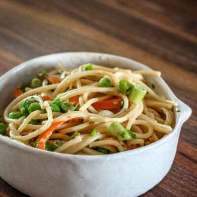 Sesame noodles in a pottery bowl.