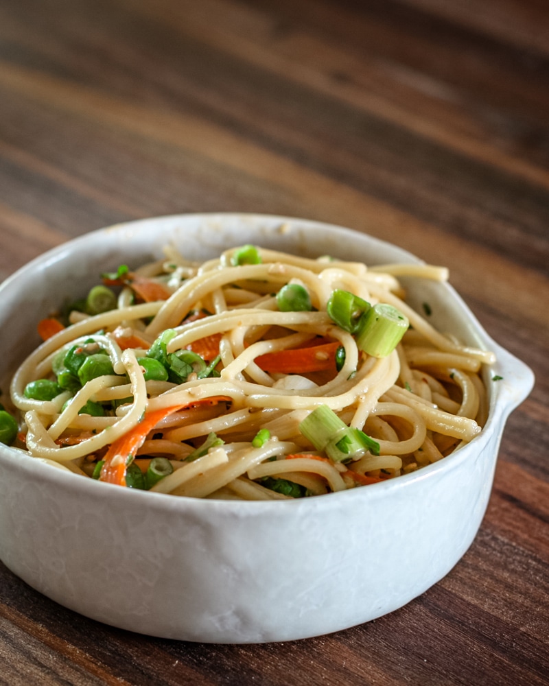 Sesame noodles in a pottery bowl.
