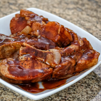 Country style ribs in sauce on a plate.