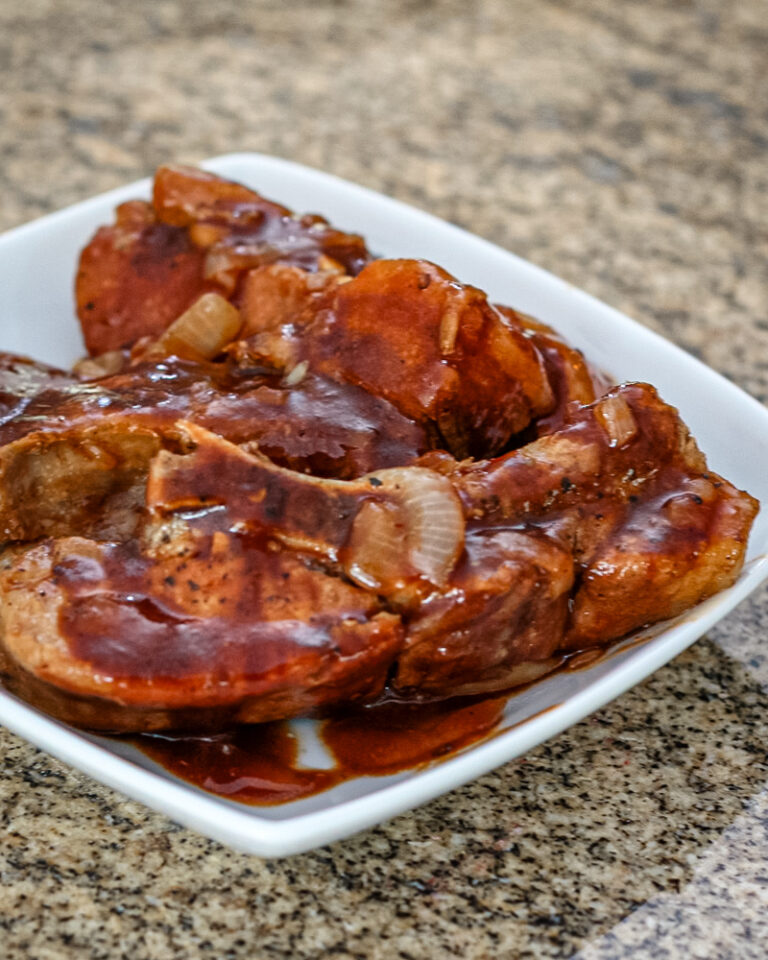 Country style ribs in sauce on a plate.