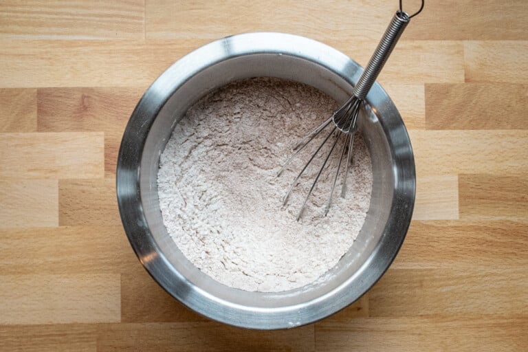 Combining dry ingredients in a bowl for baking.