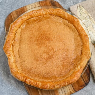 Baked chess pie with a pie server beside it.