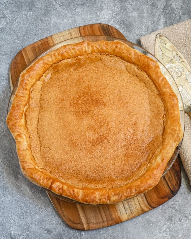 Baked chess pie with a pie server beside it.
