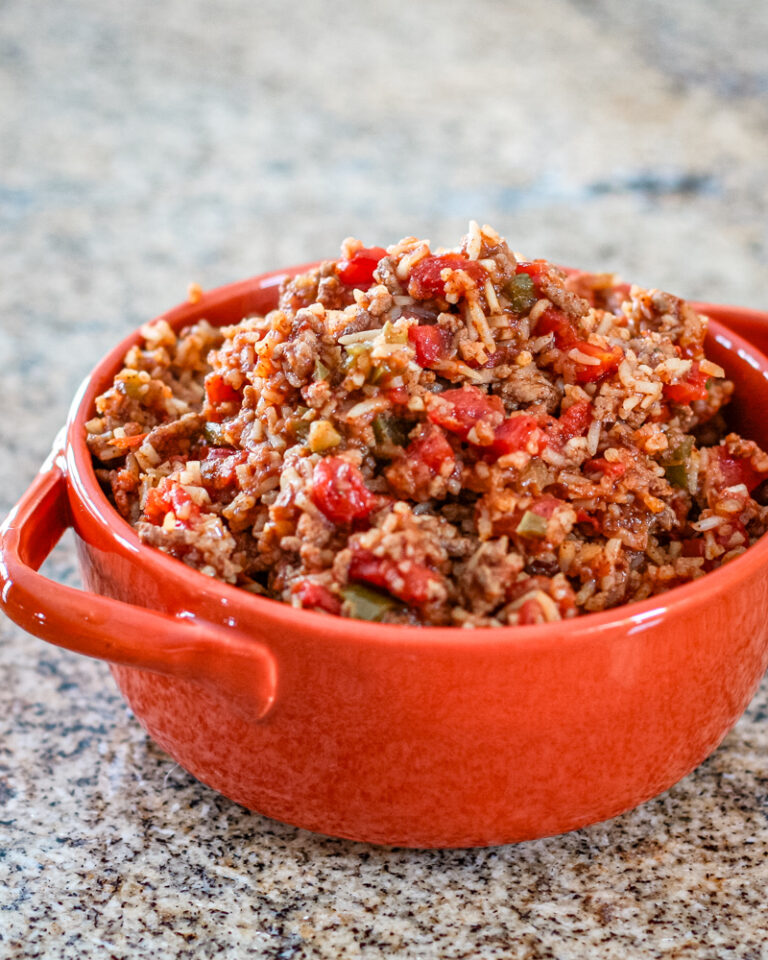 Spanish rice in an orange serving bowl.