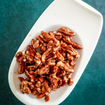A small plate with spiced pecans.