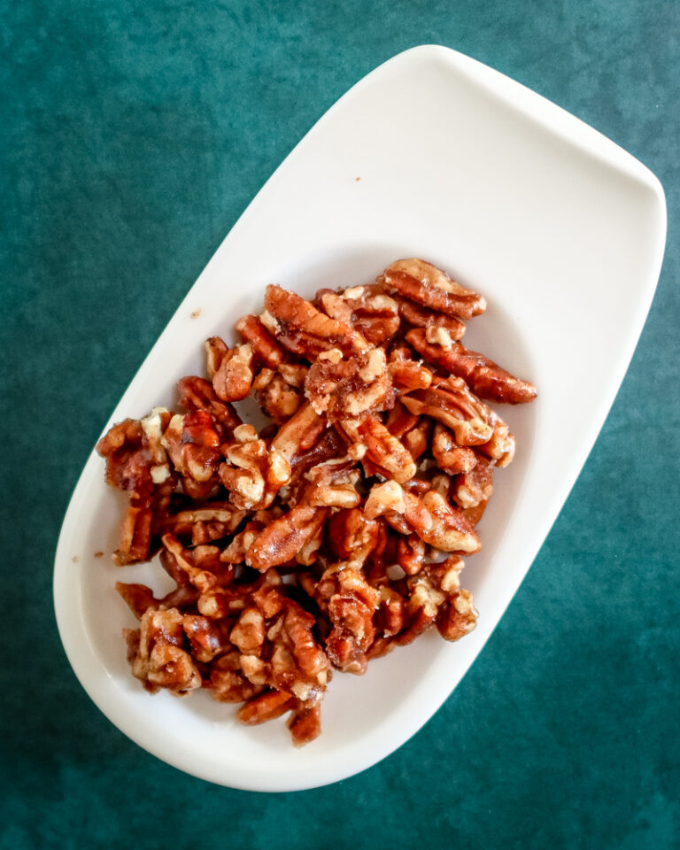 A small plate with spiced pecans.