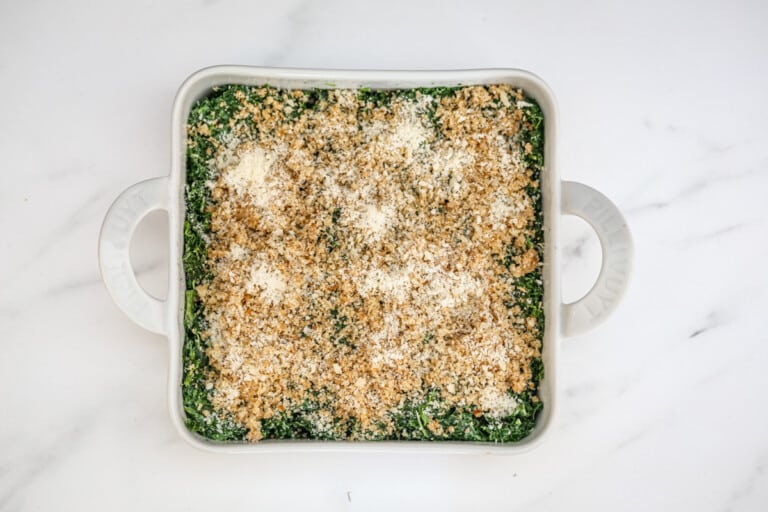 Spinach casserole in a baking dish ready to bake.