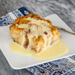 A slice of sweet potato bread pudding with vanilla sauce