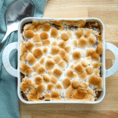 Golden toasted marshmallows on top of a baked dessert.
