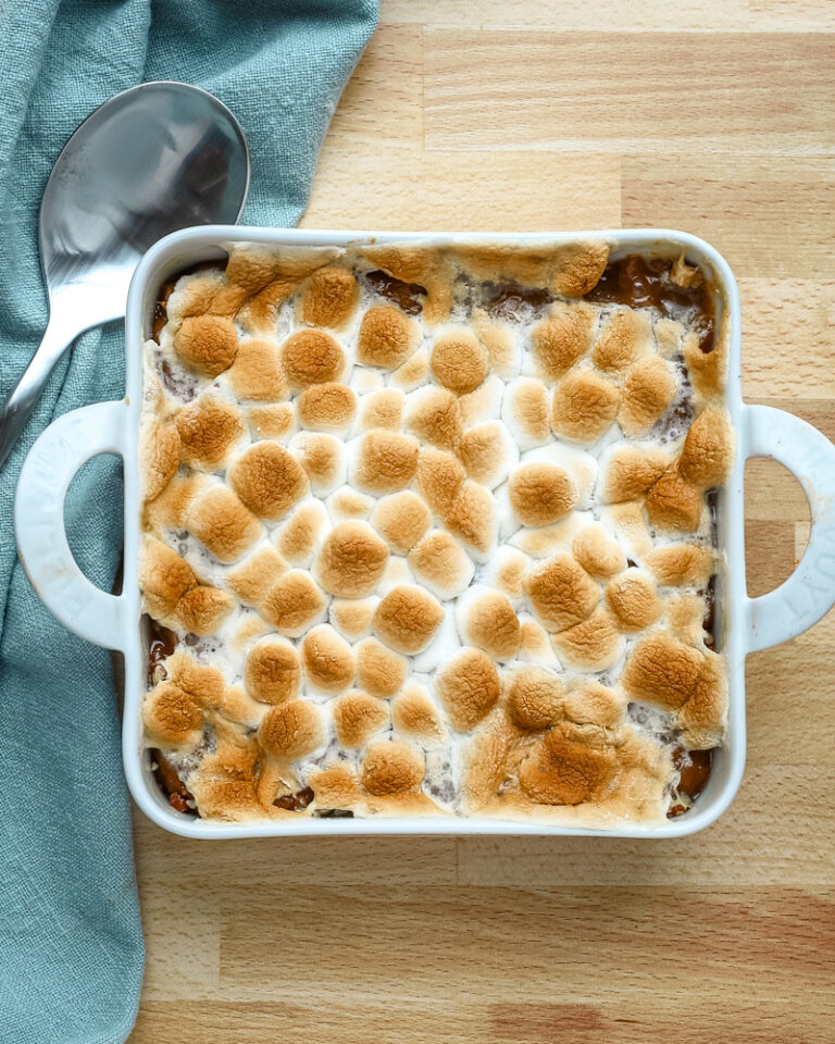 Golden toasted marshmallows on top of a baked dessert.