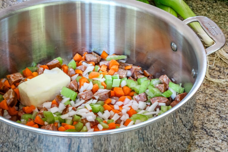Cooking the vegetables for a sausage and vegetable chowder.