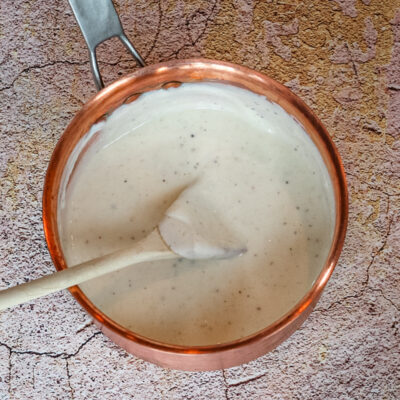 A basic bechamel sauce in a copper pot.