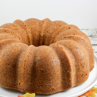 A brown sugar and pecan pound cake on a cake platter.