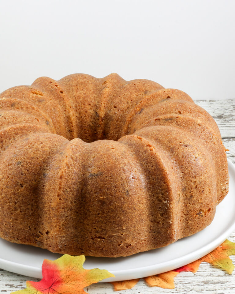 A brown sugar and pecan pound cake on a cake platter.