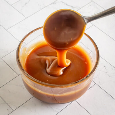 A small glass bowl of caramel sauce.