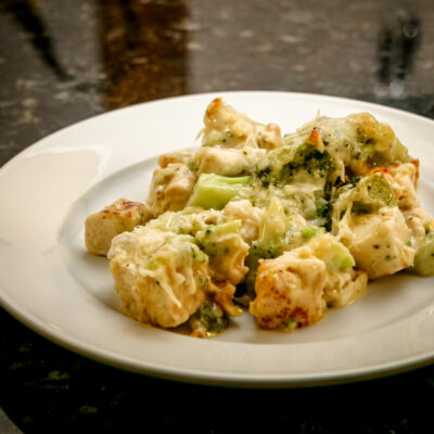 A serving of chicken and broccoli casserole on a white plate.