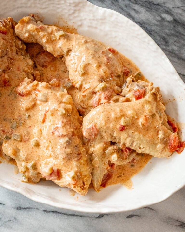 chicken paprikash with sour cream and paprika in a serving dish.