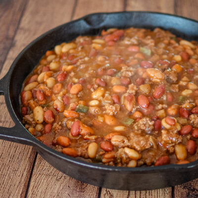 cookout beans with beef in a large iron skillet