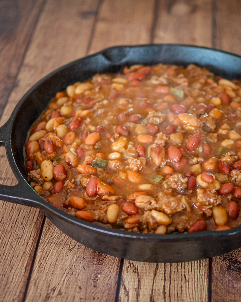 cookout beans with beef in a large iron skillet