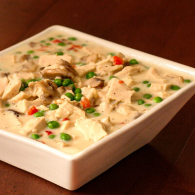 A serving bowl with creamed chicken.