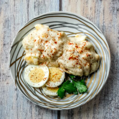creamed eggs on biscuits with sliced eggs on the side