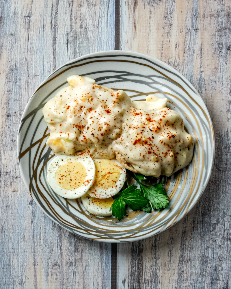 creamed eggs on biscuits with sliced eggs on the side