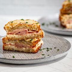 croque monsieur sandwiches on gray plates.