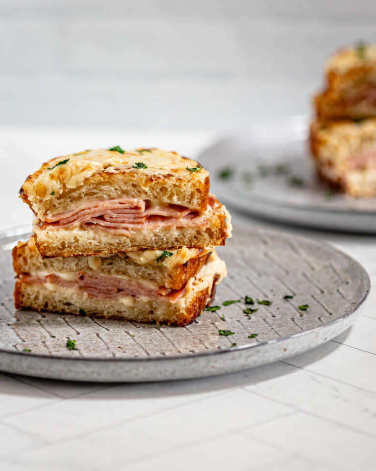 croque monsieur sandwiches on gray plates.