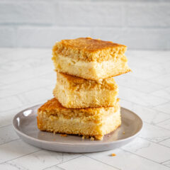 custard cornbread stacked on a small gray plate