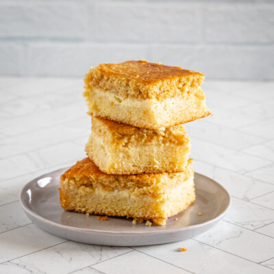 custard cornbread stacked on a small gray plate