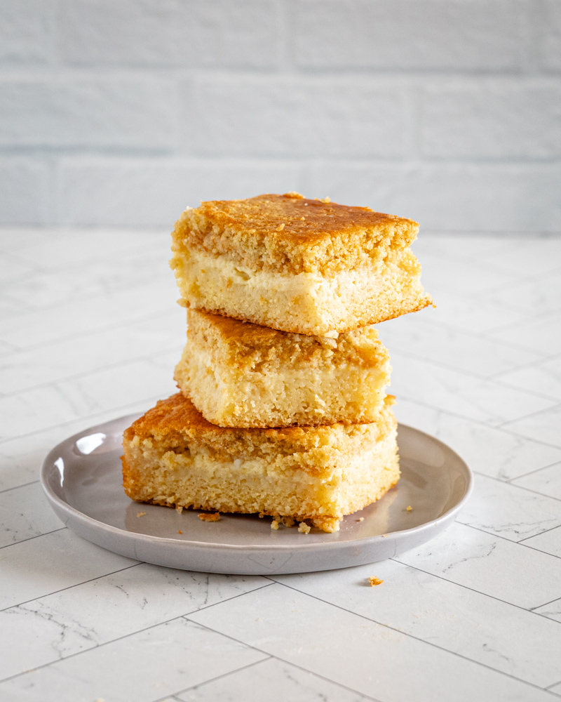 custard cornbread stacked on a small gray plate