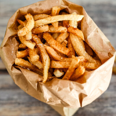 deep fried french fries in a paper bag