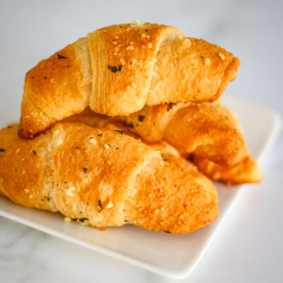 garlic butter crescent rolls on a white plate