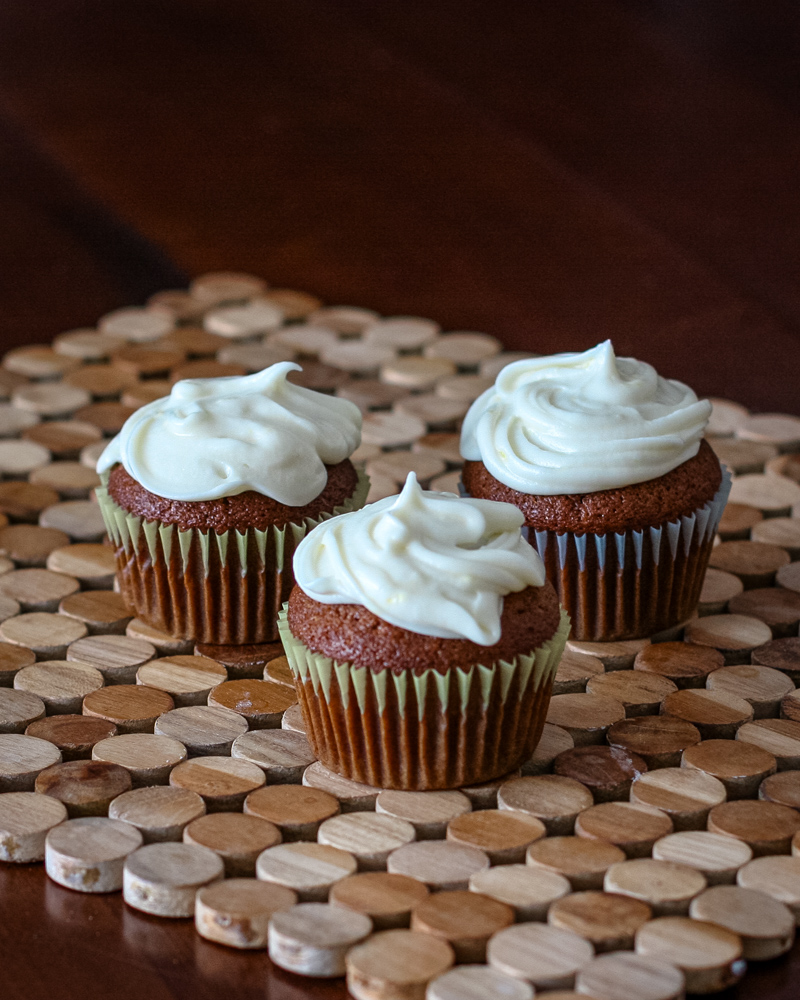 Gingerbread cupcakes topped with creamy vanilla frosting.