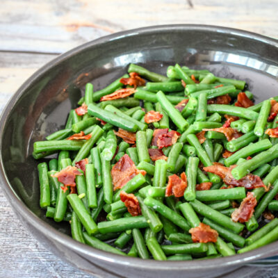 Green beans with bacon in in a DVF serving dish