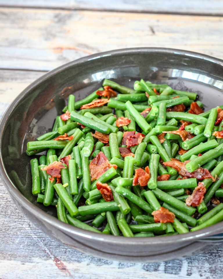 Green beans with bacon in in a DVF serving dish