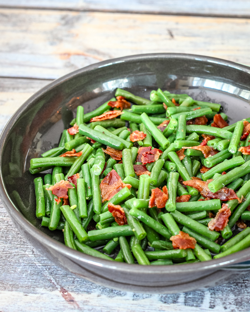 Green beans with bacon in in a DVF serving dish