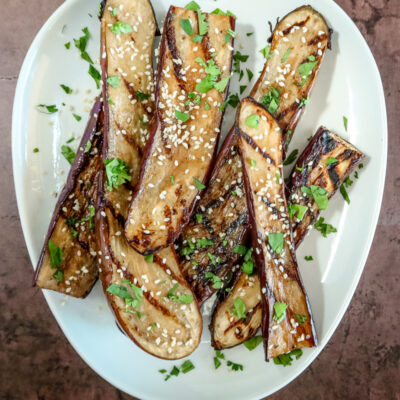 grilled chinese eggplant with sesame seeds garnish