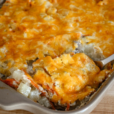 ground beef and potato casserole served with a large spoon.