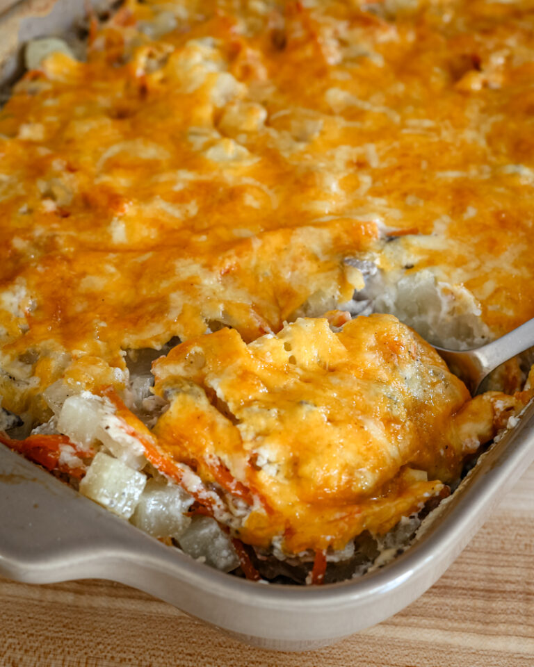 ground beef and potato casserole served with a large spoon.