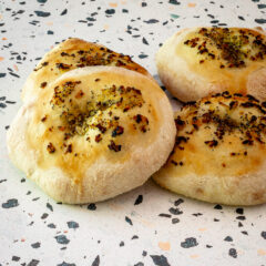 Homemade bialys on a countertop.