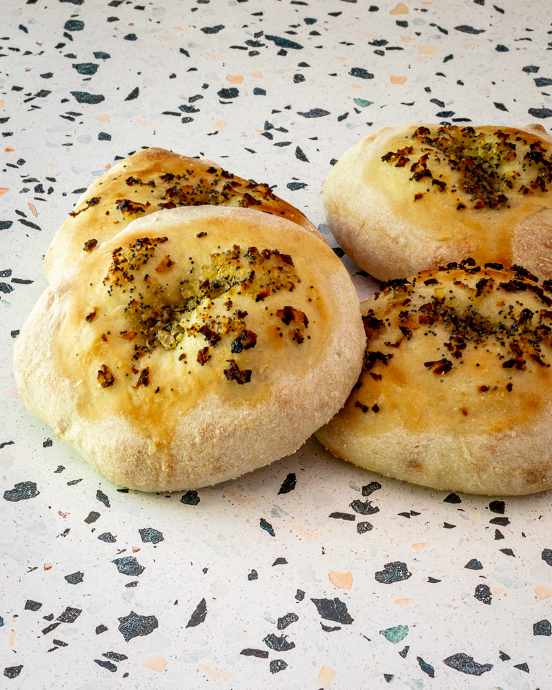 Homemade bialys on a countertop.